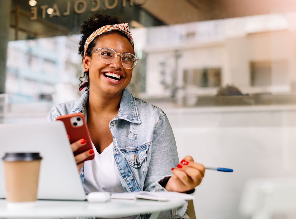 Woman with phone and laptop
